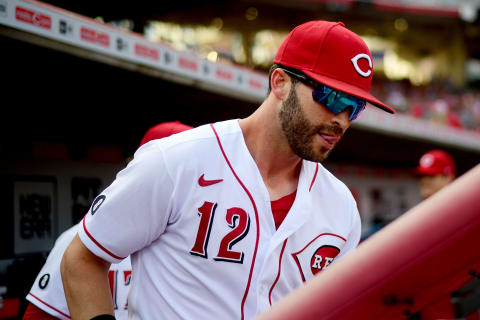 CINCINNATI, OHIO – AUGUST 21: Tyler Naquin #12 of the Cincinnati Reds walks onto the field. (Photo by Emilee Chinn/Getty Images)