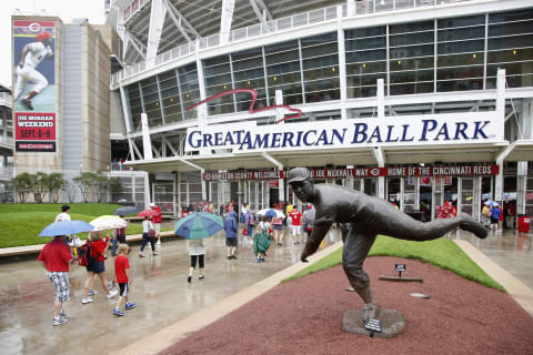 CINCINNATI, OH – JULY 4: Fans walk in the rain past the statue of former Cincinnati Reds pitcher Joe Nuxhall on their way to the game against the San Francisco Giants at Great American Ball Park on July 4, 2013 in Cincinnati, Ohio. (Photo by Joe Robbins/Getty Images)