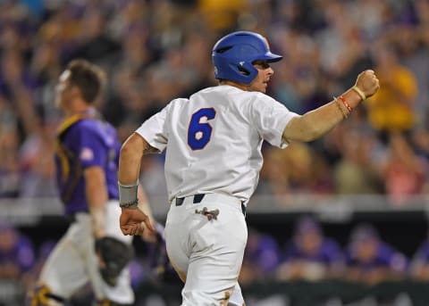 OMAHA, NE – JUNE 27: Third basemen Jonathan India #6 of the Florida Gators pumps his fist as he scores a run, after at Florida batter was hit with a pitch with the bases loaded, against the LSU Tigers in the eighth inning during game two of the College World Series Championship Series on June 27, 2017 at TD Ameritrade Park in Omaha, Nebraska. (Photo by Peter Aiken/Getty Images)