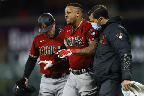 DENVER, CO – APRIL 7: Ketel Marte #4 of the Arizona Diamondbacks grimaces as he is helped off the field. (Photo by Justin Edmonds/Getty Images)