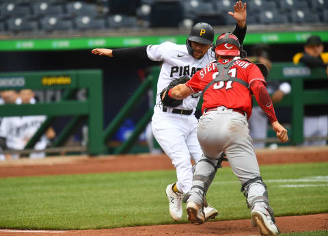 PITTSBURGH, PA – MAY 12: Adam Frazier #26 of the Pittsburgh Pirates is tagged out at home plate by Tyler Stephenson #37 of the Cincinnati Reds. (Photo by Joe Sargent/Getty Images)