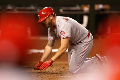 PHOENIX, ARIZONA – APRIL 09: Mike Moustakas #9 of the Cincinnati Reds reacts after being hit by a pitch during the seventh inning. (Photo by Christian Petersen/Getty Images)