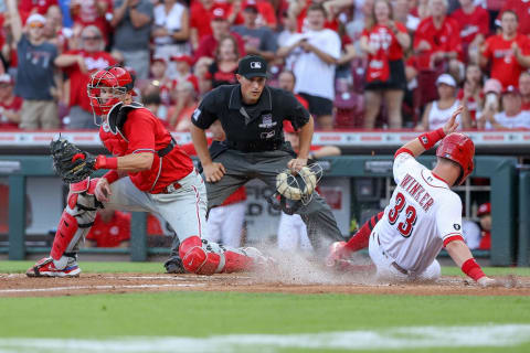 CINCINNATI, OHIO – JUNE 28: Jesse Winker #33 of the Cincinnati Reds slides into home plate to score a run. (Photo by Dylan Buell/Getty Images)