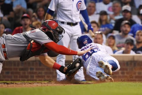 CHICAGO, ILLINOIS – JULY 27: Tyler Stephenson #37 of the Cincinnati Reds tags out Rafael Ortega #66 of the Chicago Cub. (Photo by Quinn Harris/Getty Images)