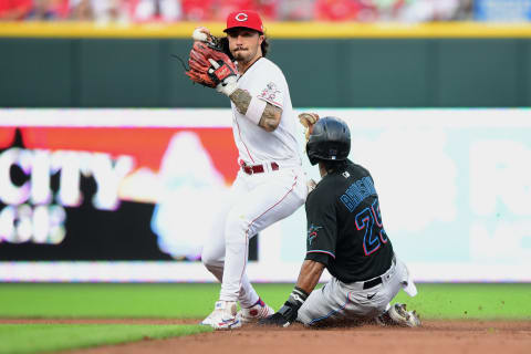 CINCINNATI, OHIO – AUGUST 21: Jonathan India #6 of the Cincinnati Reds throws to first base past Lewis Brinson #25 of the Miami Marlins. (Photo by Emilee Chinn/Getty Images)