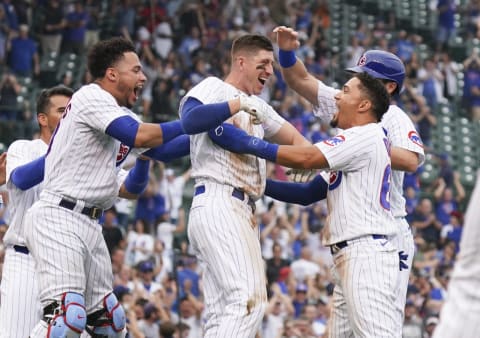 CHICAGO, ILLINOIS – SEPTEMBER 04: Frank Schwindel #18 of the Chicago Cubs is mobbed by teammates following his walk-off single. (Photo by Nuccio DiNuzzo/Getty Images)