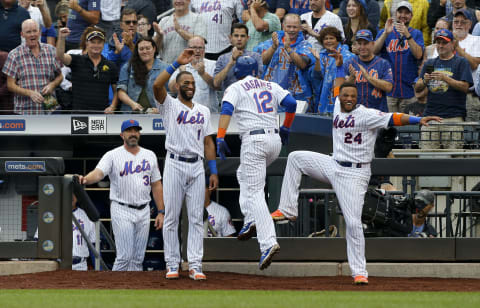 NEW YORK, NEW YORK – SEPTEMBER 12: Juan Lagares #12 of the New York Mets celebrates his third inning grand slam home run against the Arizona Diamondbacks with teammates Amed Rosario #1 and Robinson Cano #24 and manager Mickey Callaway #36 at Citi Field on September 12, 2019 in New York City. (Photo by Jim McIsaac/Getty Images)