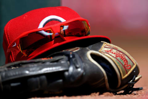 Apr 3, 2019; Cincinnati, OH, USA; A view of the stadium reflection in the Nike sunglasses on a Reds hat in the dugout in the game against the Milwaukee Brewers at Great American Ball Park. Mandatory Credit: Aaron Doster-USA TODAY Sports