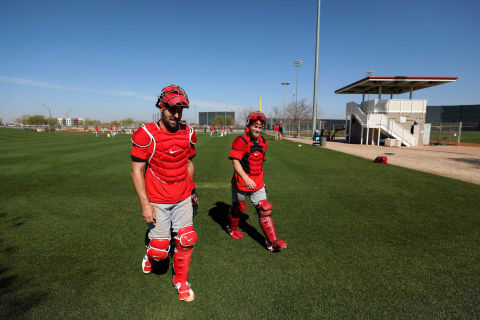 Cincinnati Reds catchers Curt Casali (12) and Tucker Barnhart (16) walk to the bullpen, Monday, Feb. 17, 2020, at the baseball team’s spring training facility in Goodyear, Ariz.Cincinnati Reds Spring Training 2 17 2020