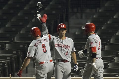 Sep 9, 2020; Chicago, Illinois, USA; Cincinnati Reds second baseman Mike Moustakas (9) celebrates with center fielder Shogo Akiyama (4) and right fielder Nick Castellanos (2) after his three run home run. Mandatory Credit: Quinn Harris-USA TODAY Sports