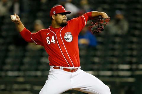 Cincinnati Reds pitcher Tony Santillan (64) throws a pitch.