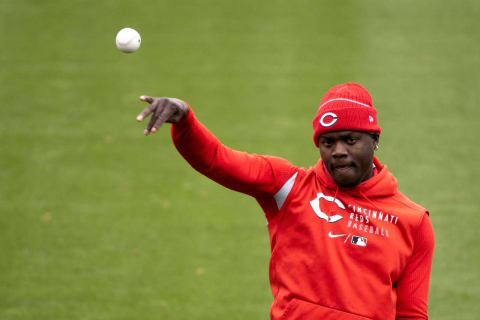 Cincinnati Reds left fielder Aristides Aquino (44) throws a ball during workouts.