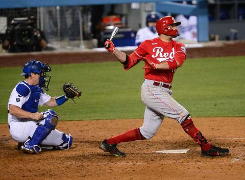 Apr 27, 2021; Los Angeles, California, USA; Cincinnati Reds first baseman Joey Votto (19) hits a two run RBI double. Mandatory Credit: Gary A. Vasquez-USA TODAY Sports