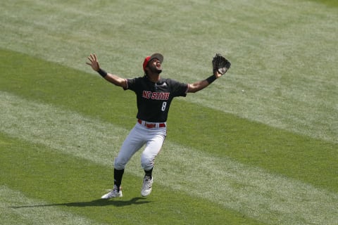 Jun 19, 2021; Omaha, Nebraska, USA; NC State Wolfpack shortstop Jose Torres (8) looks for the fly ball. Mandatory Credit: Bruce Thorson-USA TODAY Sports