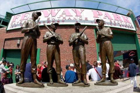 April 20, 2012; Boston, MA, USA; Fans line up at gate B and surround the statues of former Red Sox players Ted Williams (not pictured), Bobby Doerr (not pictured), Johnny Pesky (not pictured), and Dom Dimaggio (not pictured) before the start of the 100th anniversary celebration and the game between the Boston Red Sox and the New York Yankees at Fenway Park. Mandatory Credit: Greg M. Cooper-USA TODAY Sports