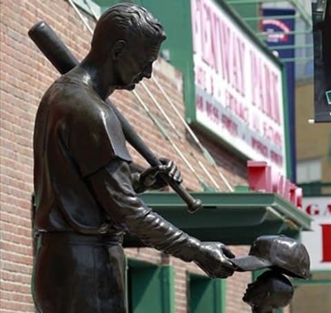 April 20, 2012; Boston, MA, USA; A statue former Boston Red Sox player Ted Williams placing a hat on a young fan near the Gate B entrance before the 100th anniversary celebration at Fenway Park before a game between the Boston Red Sox and New York Yankees. Mandatory Credit: Greg M. Cooper-USA TODAY Sports