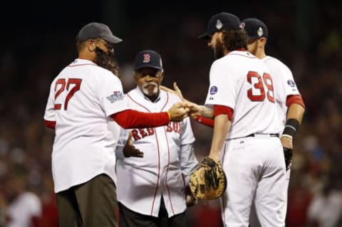 Oct 30, 2013; Boston, MA, USA; Boston Red Sox former players Carlton Fisk (left) and Luis Tiant (center) shake hands with catcher Jarrod Saltalamacchia (39) after throwing out the ceremonial first pitch prior to game six of the MLB baseball World Series against the St. Louis Cardinals at Fenway Park. Mandatory Credit: Greg M. Cooper-USA TODAY Sports