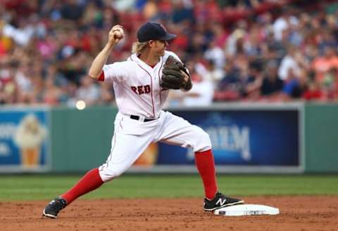 Jul 8, 2015; Boston, MA, USA; Boston Red Sox second baseman Brock Holt (26) turns a double play against the Miami Marlins during the second inning at Fenway Park. Mandatory Credit: Mark L. Baer-USA TODAY Sports