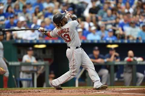 Jun 21, 2015; Kansas City, MO, USA; Boston Red Sox left fielder Hanley Ramirez (13) hits a solo home run against the Kansas City Royals during the second inning at Kauffman Stadium. Mandatory Credit: Peter G. Aiken-USA TODAY Sports