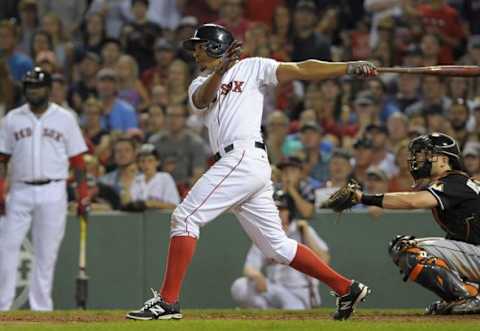 Jul 7, 2015; Boston, MA, USA; Boston Red Sox shortstop Xander Bogaerts (2) hits an RBI single scoring three runs during the seventh inning against the Miami Marlins at Fenway Park. Mandatory Credit: Bob DeChiara-USA TODAY Sports