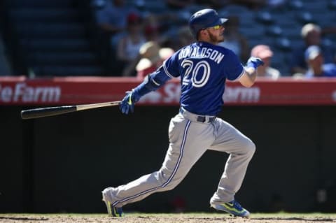 Aug 23, 2015; Anaheim, CA, USA; Toronto Blue Jays third baseman Josh Donaldson (20) hits a ball into a double play which a run scored against the Los Angeles Angels during the ninth inning at Angel Stadium of Anaheim. The Toronto Blue Jays won 12-5. Mandatory Credit: Kelvin Kuo-USA TODAY Sports