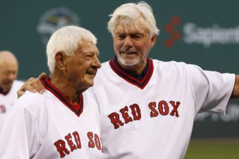 May 5, 2015; Boston, MA, USA; Boston Red Sox hall of famers Carl Yastrzemski (left) and Bill Lee share a moment as part of the pregame ceremony before the game between the Tampa Bay Rays and the Boston Red Sox at Fenway Park. Mandatory Credit: Greg M. Cooper-USA TODAY Sports