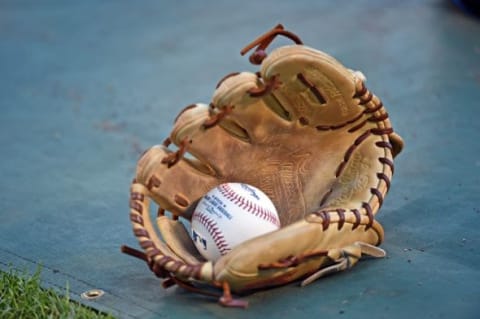 Oct 16, 2015; Kansas City, MO, USA; A general view of a glove and baseball during batting practice prior to game one of the ALCS between the Kansas City Royals and the Toronto Blue Jays at Kauffman Stadium. Mandatory Credit: Peter G. Aiken-USA TODAY Sports