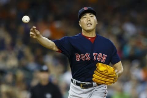 Aug 7, 2015; Detroit, MI, USA; Boston Red Sox relief pitcher Koji Uehara (19) makes a throw to first after get struck by a ball hit by Detroit Tigers second baseman Ian Kinsler (not pictured) in the ninth inning at Comerica Park. The Red Sox won 7-2. Mandatory Credit: Rick Osentoski-USA TODAY Sports