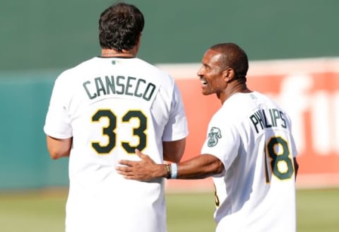 Jul 19, 2014; Oakland, CA, USA; Oakland Athletics former players Jose Canseco (33) and Tony Phillips (18) during the celebration of the 1989 Oakland Athletics World Series Champions before the game against Baltimore Orioles at O.co Coliseum. Mandatory Credit: Bob Stanton-USA TODAY Sports