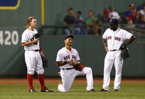 Sep 8, 2015; Boston, MA, USA; (From left to right) Boston Red Sox second baseman Brock Holt (26), center fielder Mookie Betts (50) and right fielder Jackie Bradley Jr. (25) speak during a pitching change during the seventh inning of a game against the Toronto Blue Jays at Fenway Park. Mandatory Credit: Mark L. Baer-USA TODAY Sports