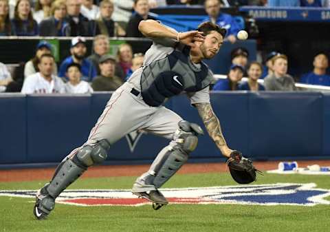 Apr 9, 2016; Toronto, Ontario, CAN; Boston Red Sox catcher Blake Swihart (23) is struck in the face by a pop foul he failed to field against Toronto Blue Jay at Rogers Centre. Mandatory Credit: Dan Hamilton-USA TODAY Sports