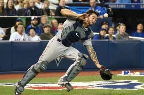 Apr 9, 2016; Toronto, Ontario, CAN; Boston Red Sox catcher Blake Swihart (23) is struck in the face by a pop foul he failed to field against Toronto Blue Jay at Rogers Centre. Mandatory Credit: Dan Hamilton-USA TODAY Sports