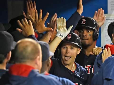 Apr 8, 2016; Toronto, Ontario, CAN; Boston Red Sox left fielder Brock Holt (12) sticks out his tongue as he celebrates in the dugout after hitting a grand slam home run against Toronto Blue Jays in the fifth inning at Rogers Centre. Mandatory Credit: Dan Hamilton-USA TODAY Sports