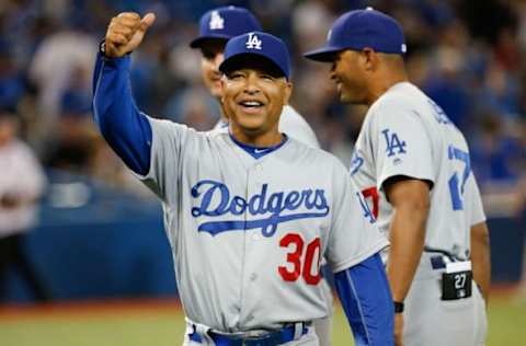 May 7, 2016; Toronto, Ontario, CAN; Los Angeles Dodgers manager Dave Roberts (30) gives the thumbs to LA Dodger fans after defeating the Toronto Blue Jays 6-2 at Rogers Centre. Mandatory Credit: Kevin Sousa-USA TODAY Sports