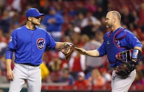 Apr 22, 2016; Cincinnati, OH, USA; Chicago Cubs relief pitcher Justin Grimm (left) is congratulated by catcher David Ross (right) after the Cubs defeated the Cincinnati Reds 8-1 at Great American Ball Park. Mandatory Credit: David Kohl-USA TODAY Sports