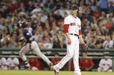 May 26, 2016; Boston, MA, USA; Boston Red Sox starting pitcher Clay Buchholz (11) watches as Colorado Rockies catcher Dustin Garneau (13) rounds the bases after hitting a two run homer in the fifth inning at Fenway Park. Mandatory Credit: David Butler II-USA TODAY Sports