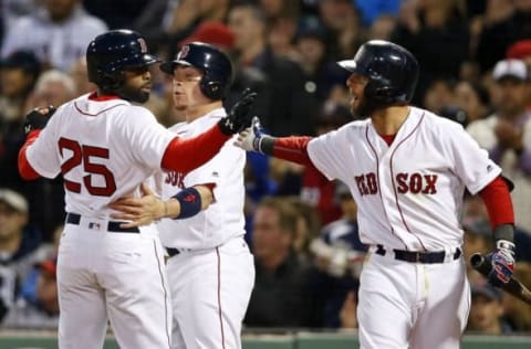 Apr 30, 2016; Boston, MA, USA; Boston Red Sox center fielder Jackie Bradley Jr. (25) and catcher Christian Vazquez (7) are congratulated by second baseman Dustin Pedroia (15) after scoring during the second inning against the New York Yankees at Fenway Park. Mandatory Credit: Greg M. Cooper-USA TODAY Sports