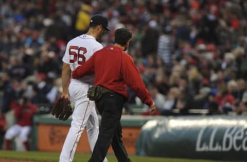 Apr 19, 2016; Boston, MA, USA; Boston Red Sox starting pitcher Joe Kelly (56) walks off the mound with a member of the training staff during the first inning against the Tampa Bay Rays at Fenway Park. Mandatory Credit: Bob DeChiara-USA TODAY Sports