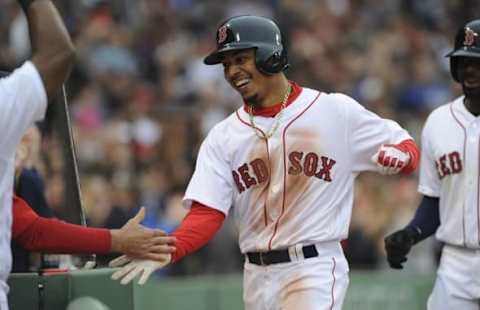 May 21, 2016; Boston, MA, USA; Boston Red Sox right fielder Mookie Betts (50) is greeted in the dugout after hitting a grand slam during the seventh inning against the Cleveland Indians at Fenway Park. Mandatory Credit: Bob DeChiara-USA TODAY Sports