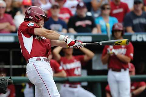 Jun 13, 2015; Omaha, NE, USA; Arkansas Razorbacks outfielder Andrew Benintendi (16) hits a sacrifice RBI against the Virginia Cavaliers in the third inning in the 2015 College World Series at TD Ameritrade Park. Mandatory Credit: Steven Branscombe-USA TODAY Sports