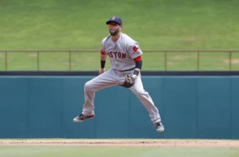 Jun 26, 2016; Arlington, TX, USA; Boston Red Sox second baseman Dustin Pedroia (15) hops in the air during a pitch in the second inning against the Texas Rangers at Globe Life Park in Arlington. Texas won 6-2. Mandatory Credit: Tim Heitman-USA TODAY Sports