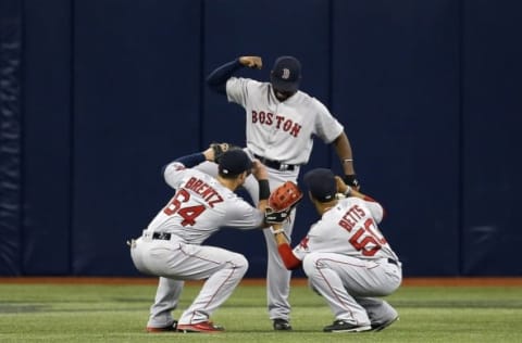 Jun 28, 2016; St. Petersburg, FL, USA; Boston Red Sox left fielder Bryce Brentz (64), center fielder Jackie Bradley Jr. (25) and right fielder Mookie Betts (50) celebrate in the dugout after they beat the Tampa Bay Rays at Tropicana Field. Boston Red Sox defeated the Tampa Bay Rays 8-2. Mandatory Credit: Kim Klement-USA TODAY Sports