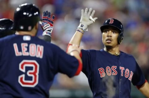 Jun 24, 2016; Arlington, TX, USA; Boston Red Sox right fielder Mookie Betts (right) celebrates his game tying two-run home run with catcher Sandy Leon (3) against the Texas Rangers during the ninth inning of a baseball game at Globe Life Park in Arlington. The Red Sox won 8-7. Mandatory Credit: Jim Cowsert-USA TODAY Sports