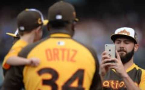 Jul 11, 2016; San Diego, CA, USA; National League pitcher Jake Arrieta (49) of the Chicago Cubs takes a photo of his son with David Ortiz (34) during the All Star Game home run derby at PetCo Park. Mandatory Credit: Jake Roth-USA TODAY Sports