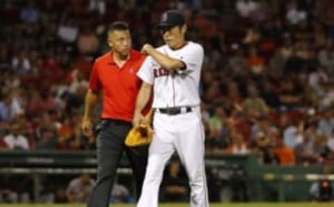 Jul 19, 2016; Boston, MA, USA; Boston Red Sox relief pitcher Koji Uehara (19) is led off the field by a trainer after he was injured at Fenway Park. Mandatory Credit: Winslow Townson-USA TODAY Sports