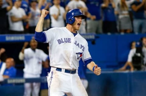 Jul 7, 2016; Toronto, Ontario, CAN; Toronto Blue Jays left fielder Michael Saunders (21) reacts after scoring the winning run in the eighth inning against the Detroit Tigers at Rogers Centre. Blue Jays won 5-4. Mandatory Credit: Kevin Sousa-USA TODAY Sports