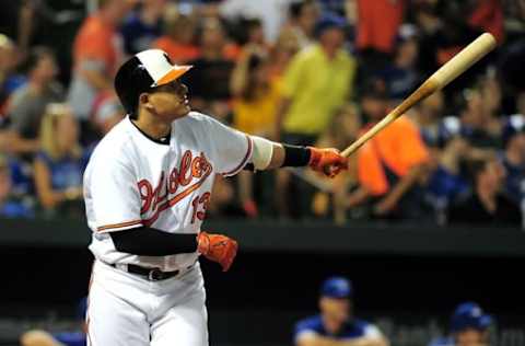 Aug 30, 2016; Baltimore, MD, USA; Baltimore Orioles third baseman Manny Machado (13) hits his 100th career home run in the fifth inning against the Toronto Blue Jays at Oriole Park at Camden Yards. Mandatory Credit: Evan Habeeb-USA TODAY Sports