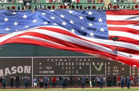 Jul 4, 2016; Boston, MA, USA; An American flag is unfurled on the Green Monster left field wall during the National Anthem before the game between the Boston Red Sox and the Texas Rangers at Fenway Park. Mandatory Credit: Winslow Townson-USA TODAY Sports