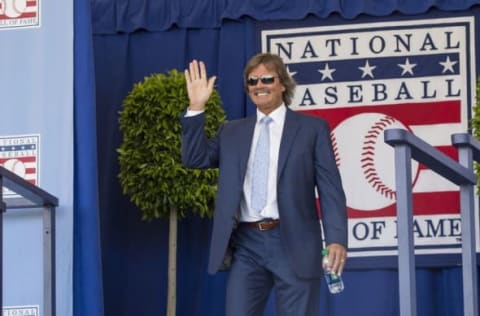 Jul 24, 2016; Cooperstown, NY, USA; Hall of Famer Dennis Eckersley waves after being introduced during the 2016 MLB baseball hall of fame induction ceremony at Clark Sports Center. Mandatory Credit: Gregory J. Fisher-USA TODAY Sports