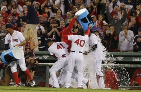 Sep 15, 2016; Boston, MA, USA; Boston Red Sox first baseman Hanley Ramirez (13) gets dowsed with water after hitting a game winning three run homer against the New York Yankees in the ninth inning at Fenway Park. The Boston Red Sox defeated the Yankees 7-5. Mandatory Credit: David Butler II-USA TODAY Sports